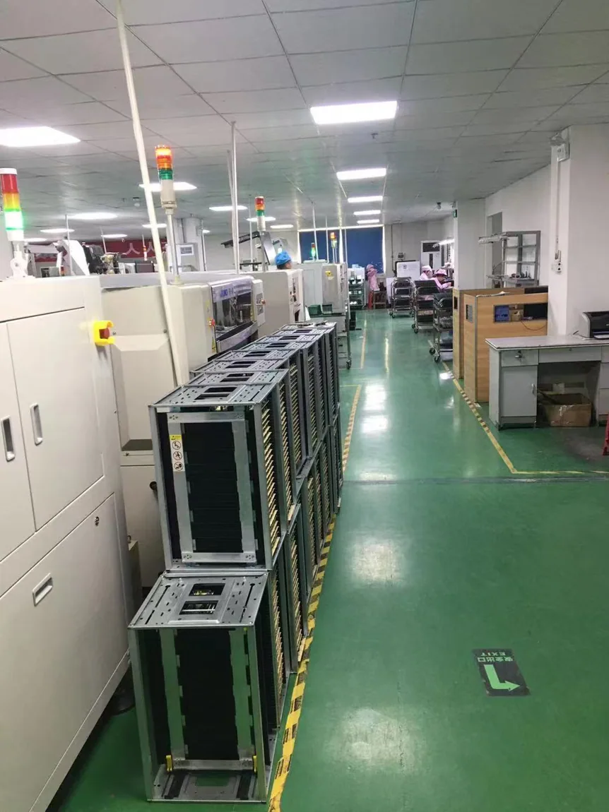 User-supplied real photograph of manufacturing aisle with equipment and material racks