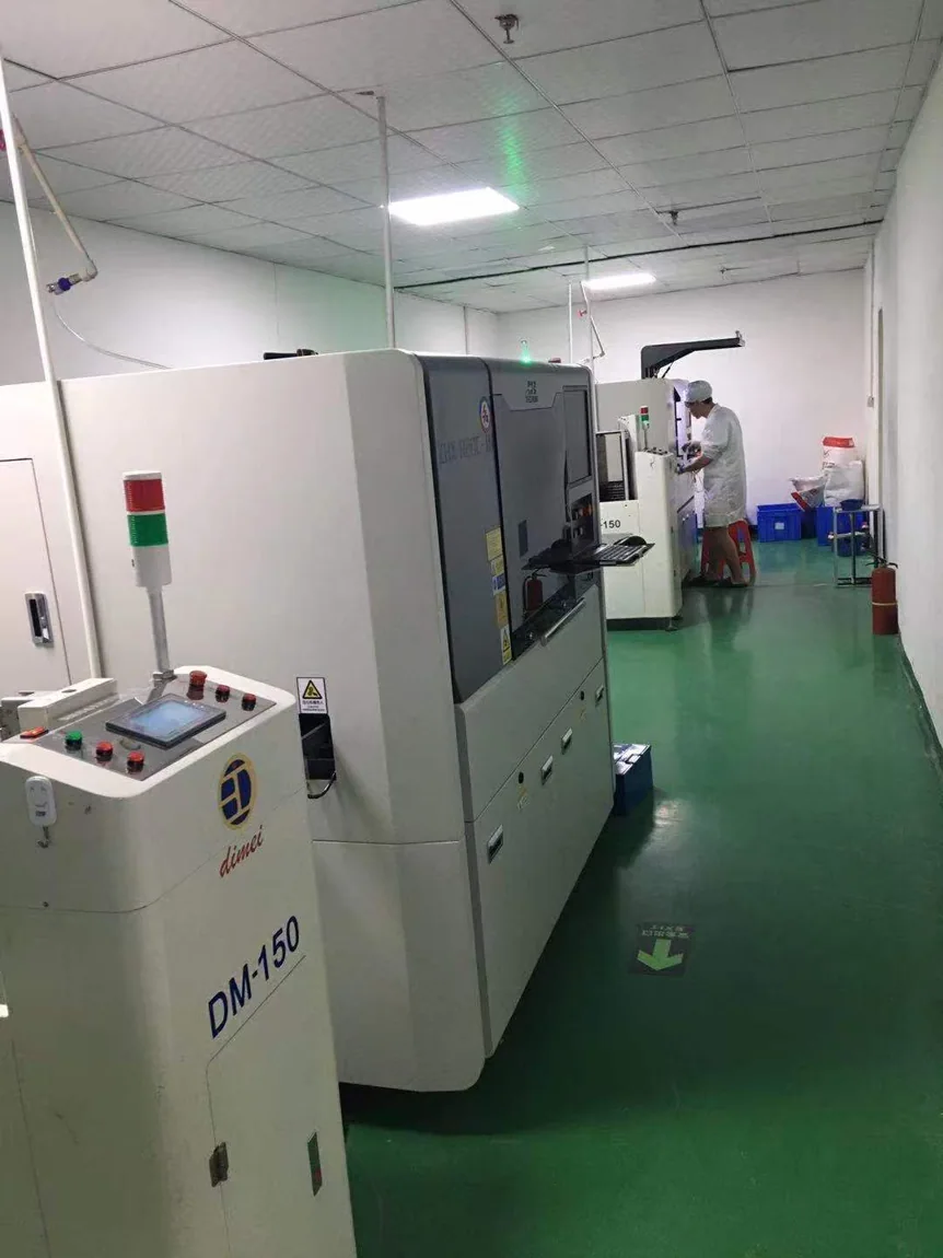Documentary photograph of real post-SMT equipment aisle in supplied workshop