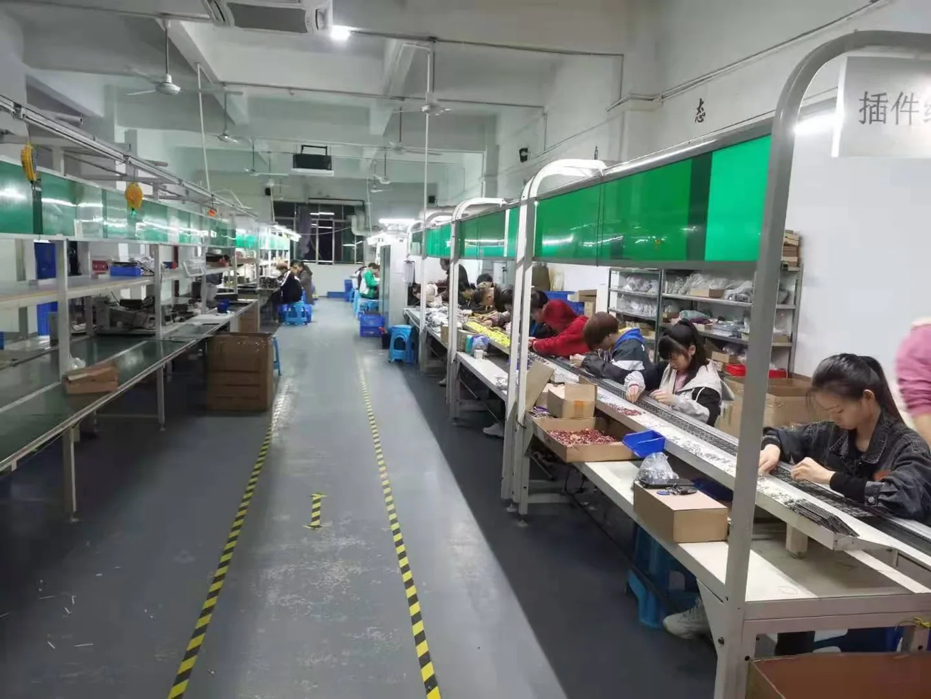 Actual long bench assembly area with operators