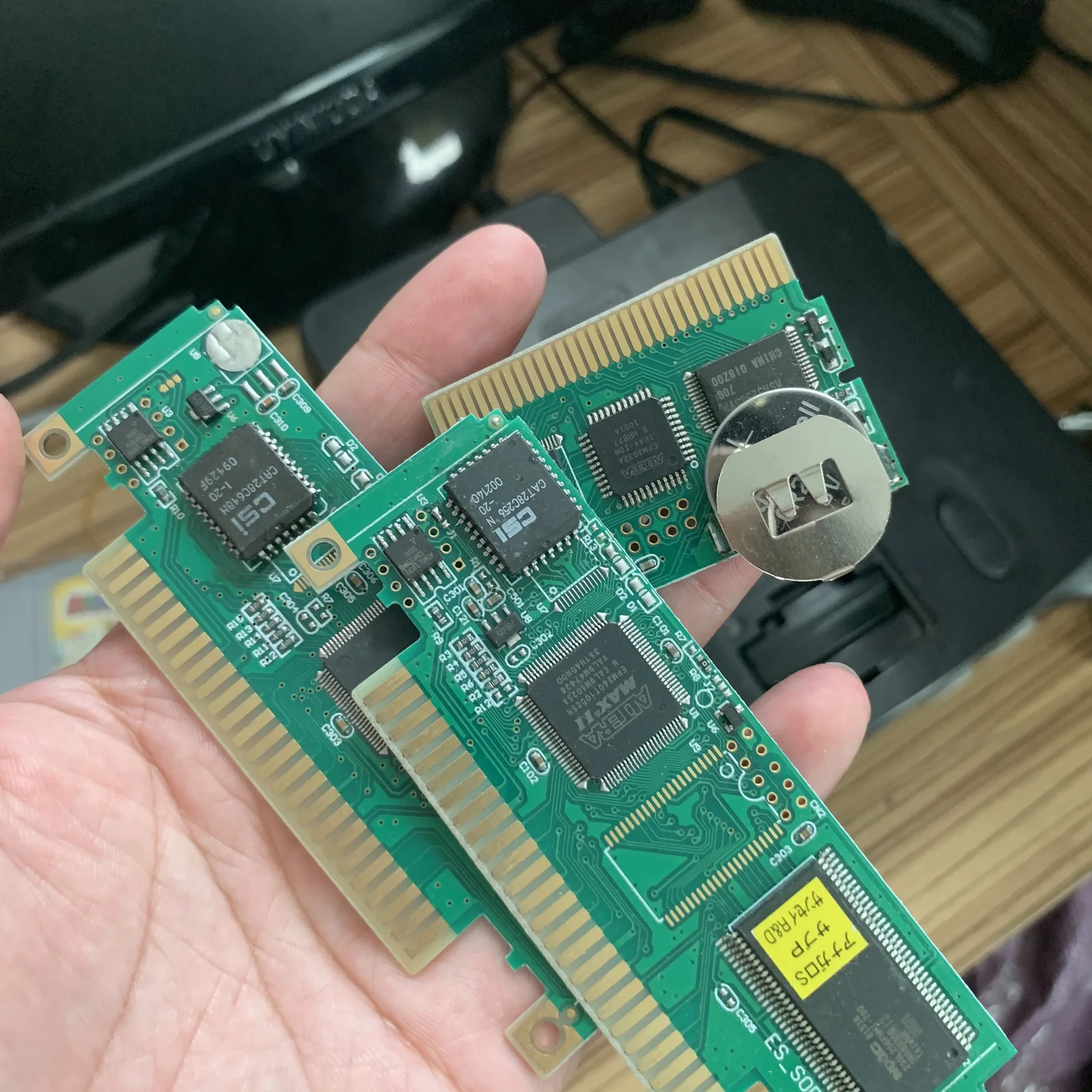 Original close-up photograph of cartridge PCBs with exposed chips and gold edge contacts